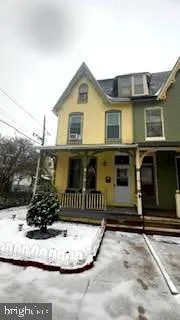a view of a house with more windows and potted plants