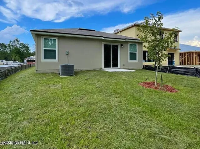 a house that has a tree in front of it