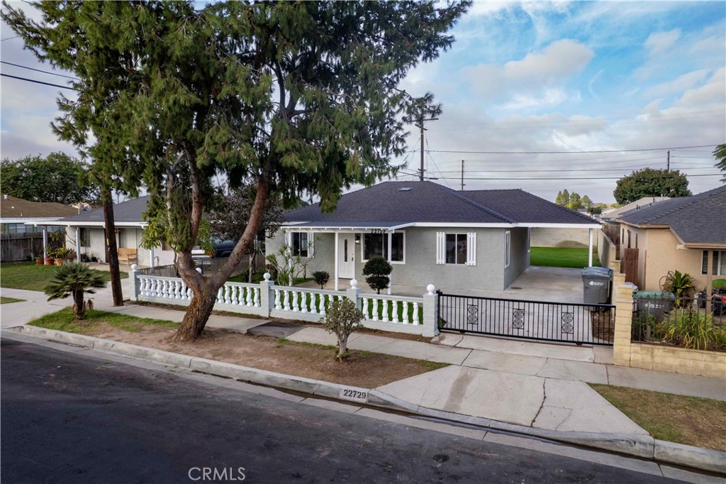 22729 Marbella Avenue Carson, CA 90745 - Photo 12 of 57 a front view of a house with a garden
