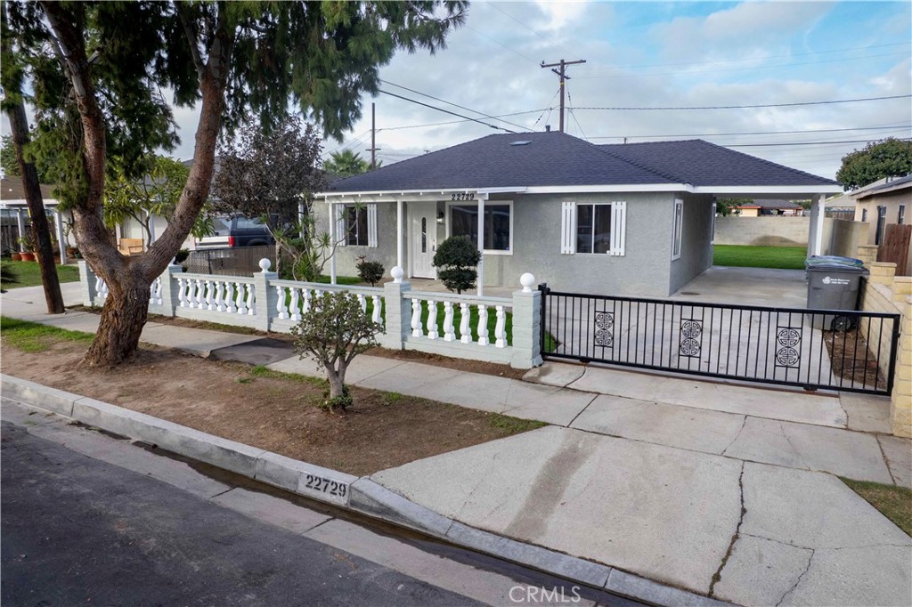 22729 Marbella Avenue Carson, CA 90745 - Photo 13 of 57 a front view of a house with a yard