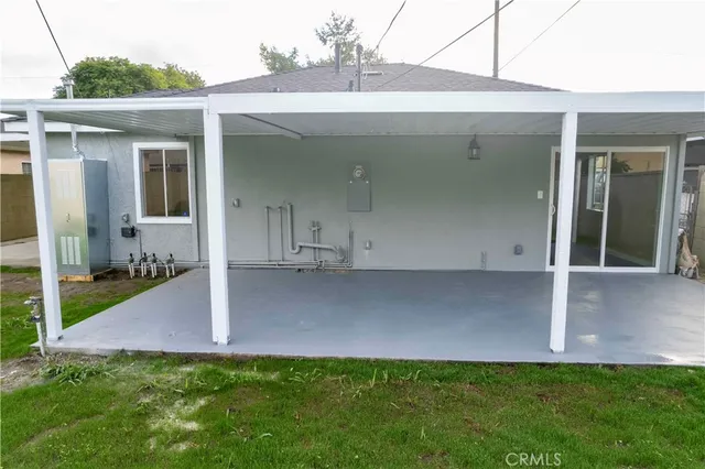 a view of a house with a yard and a porch