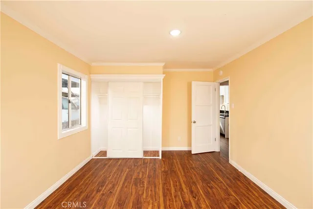 a view of a room with wooden floor and entrance
