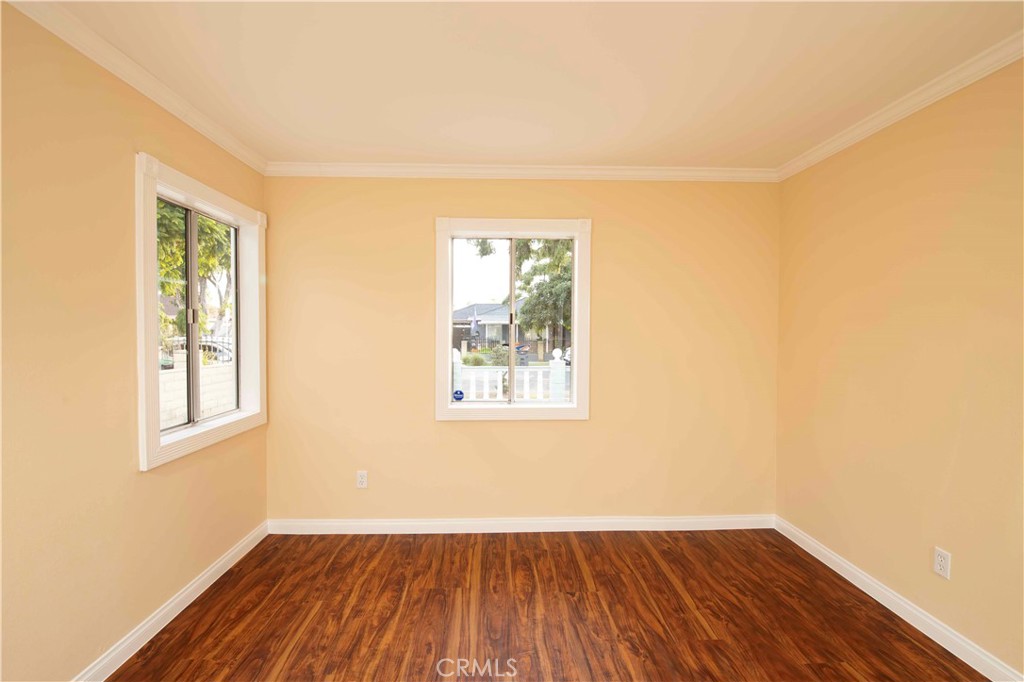 22729 Marbella Avenue Carson, CA 90745 - Photo 36 of 57 an empty room with wooden floor and windows