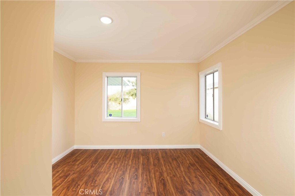 22729 Marbella Avenue Carson, CA 90745 - Photo 39 of 57 an empty room with wooden floor and windows