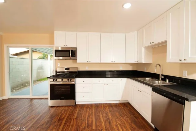 a stove top oven sitting inside of a kitchen