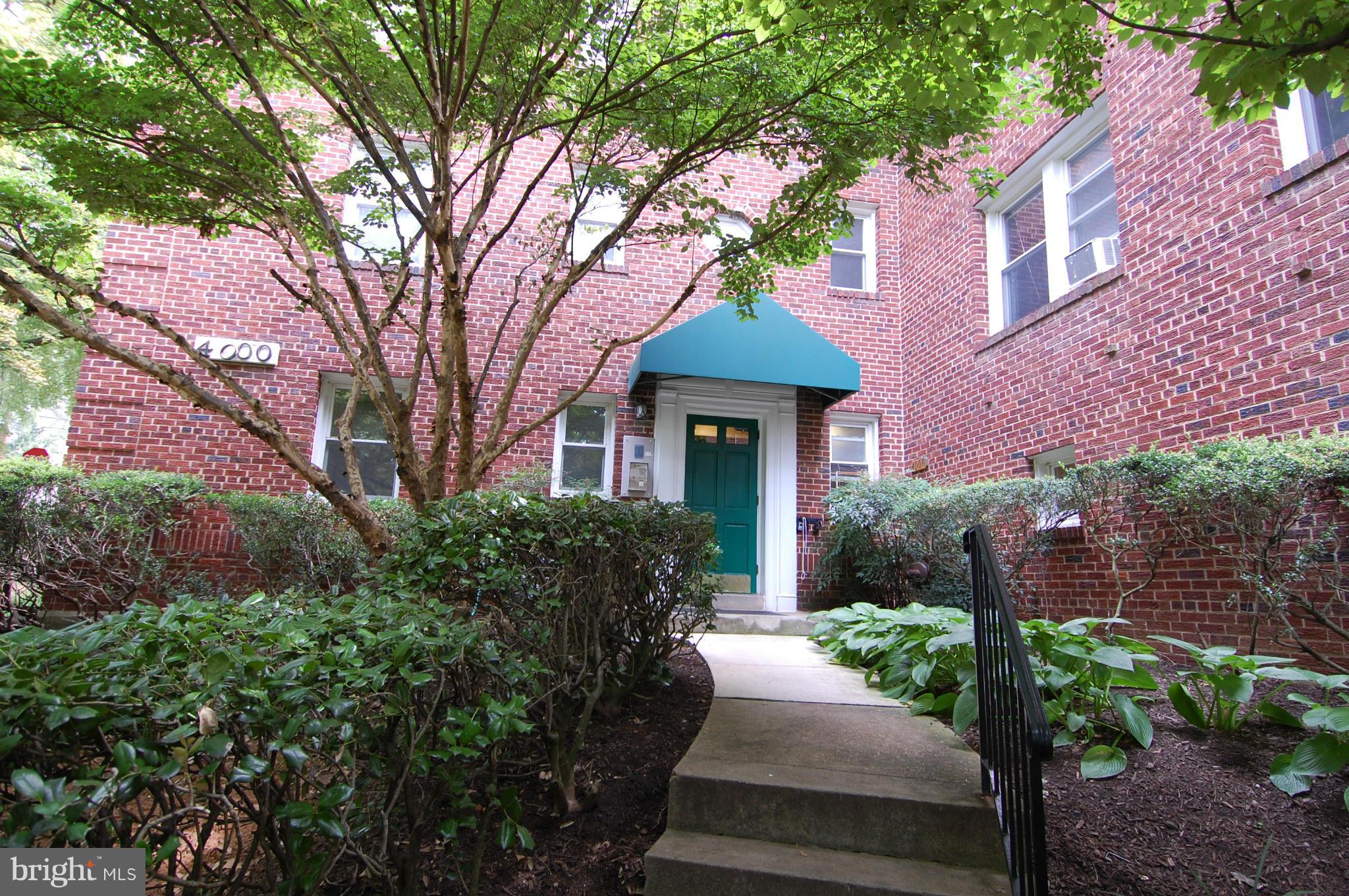 4000 Beecher Street Northwest, Unit 101 Washington, DC 20007 - Photo 1 of 26 a front view of a house with garden