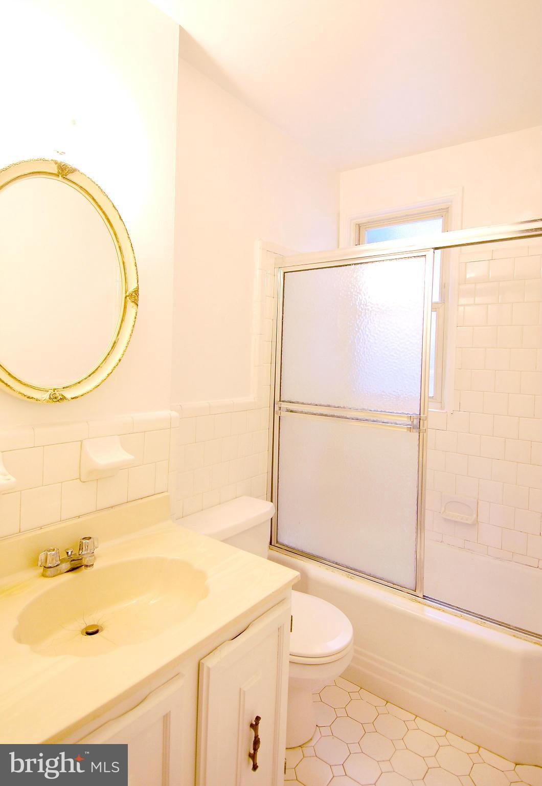 4000 Beecher Street Northwest, Unit 101 Washington, DC 20007 - Photo 13 of 26 a bathroom with a sink and a mirror