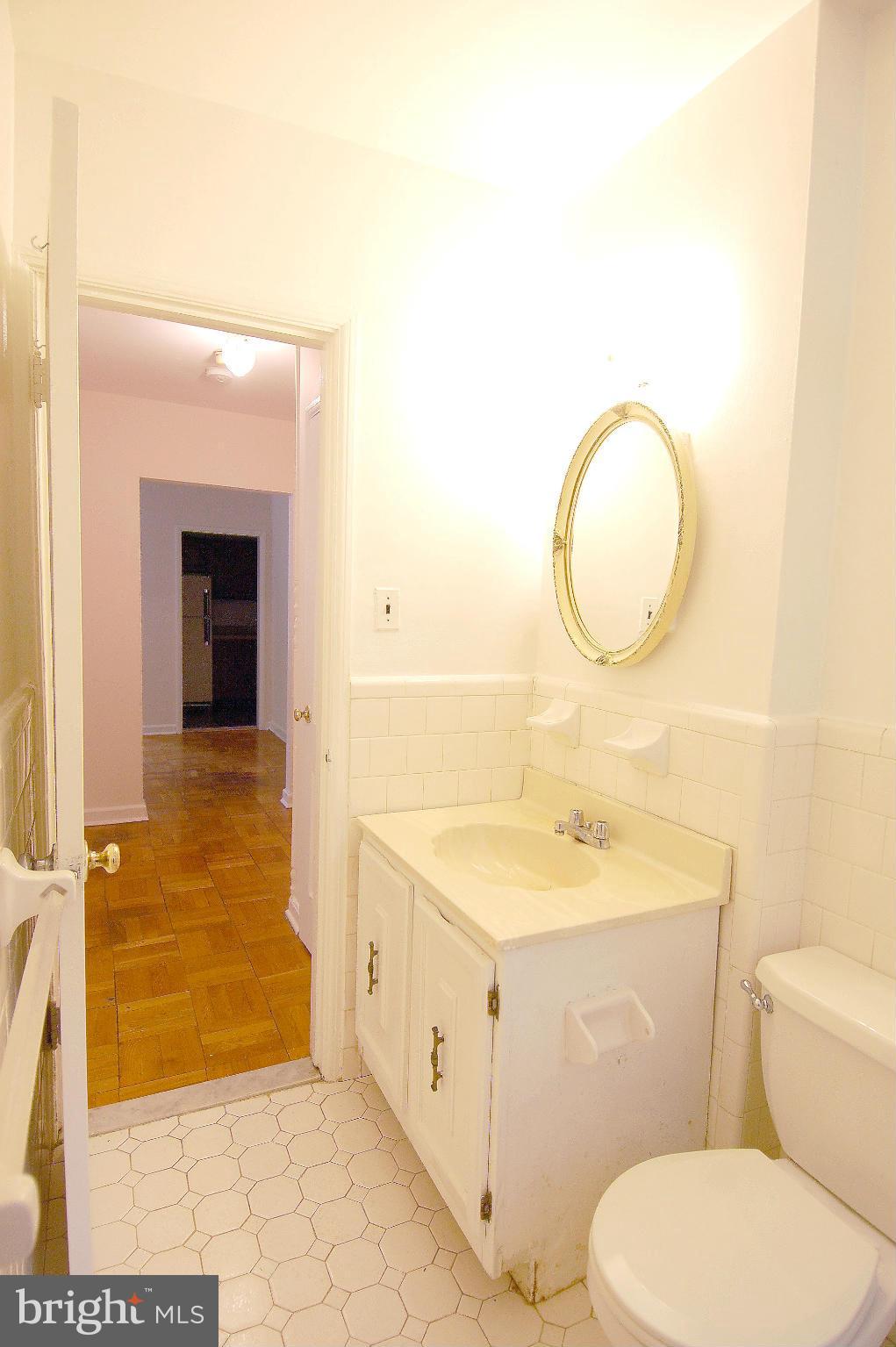 4000 Beecher Street Northwest, Unit 101 Washington, DC 20007 - Photo 14 of 26 a bathroom with a sink a toilet and shower