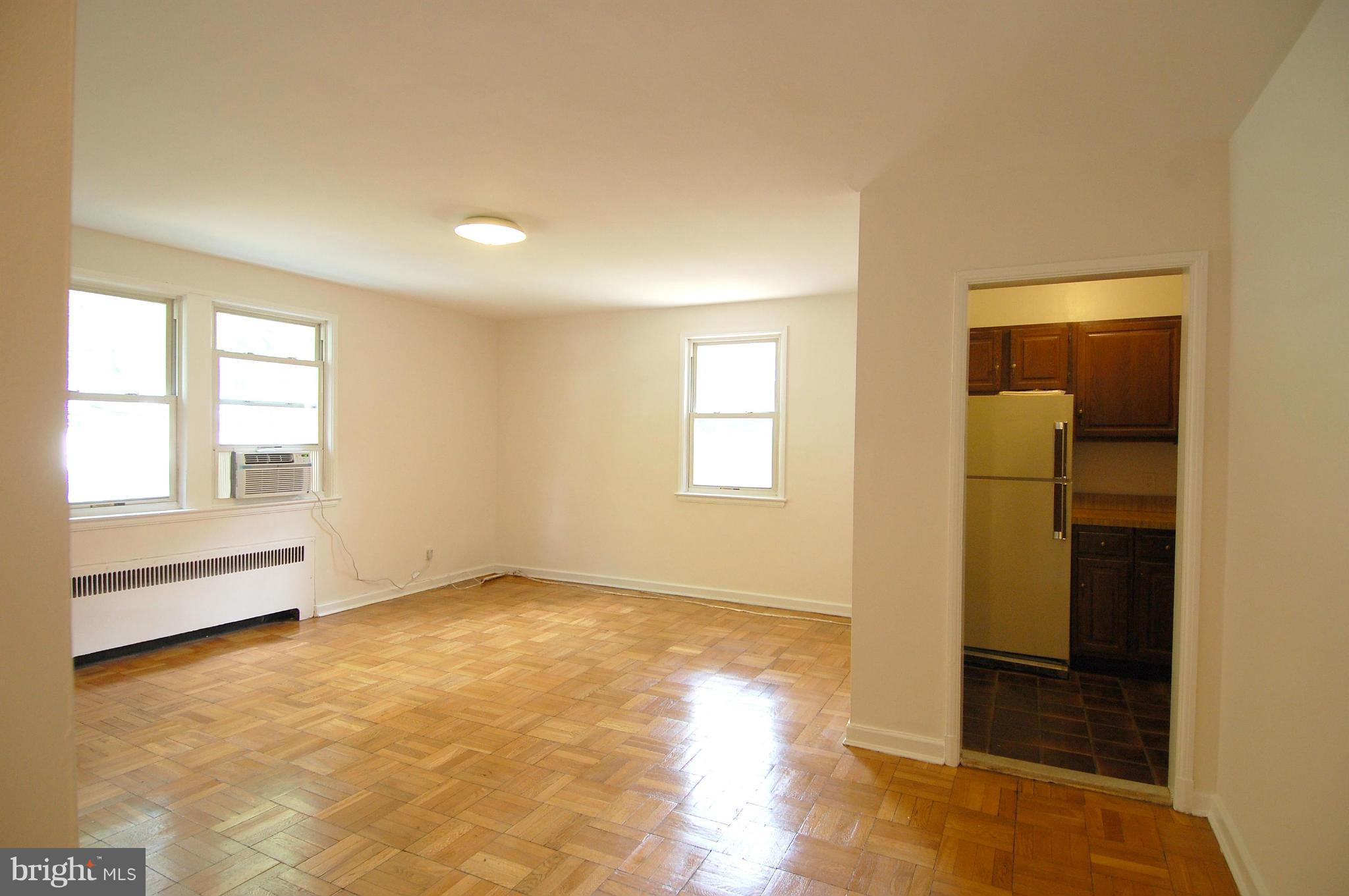 4000 Beecher Street Northwest, Unit 101 Washington, DC 20007 - Photo 3 of 26 an empty room with windows and closet