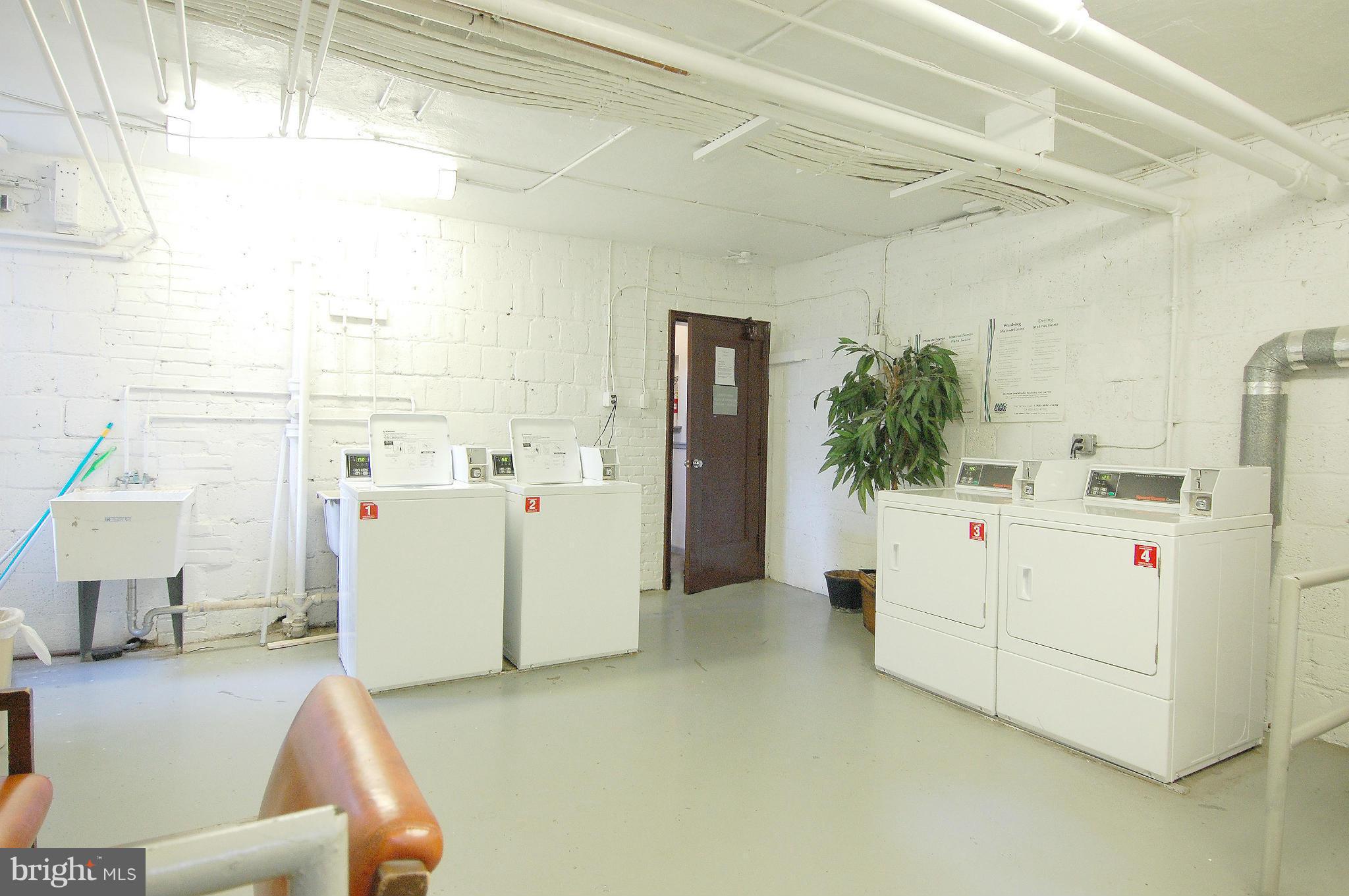 4000 Beecher Street Northwest, Unit 101 Washington, DC 20007 - Photo 22 of 26 a utility room with cabinets