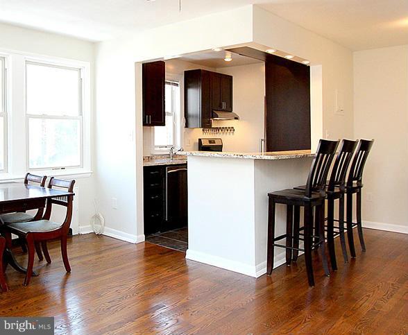 4000 Beecher Street Northwest, Unit 101 Washington, DC 20007 - Photo 23 of 26 a view of a dining room with furniture and wooden floor