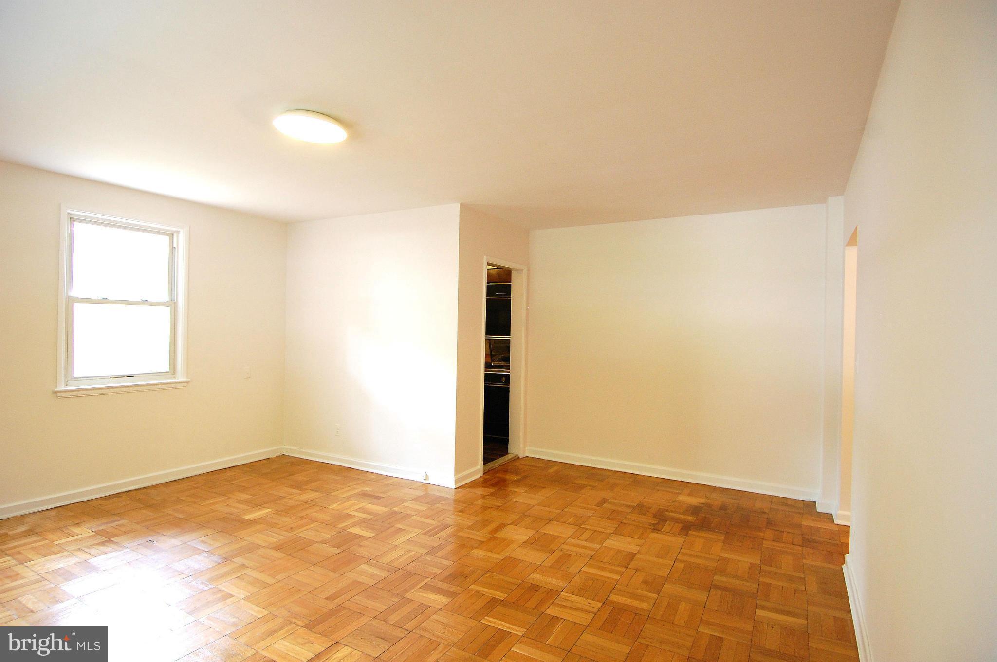 4000 Beecher Street Northwest, Unit 101 Washington, DC 20007 - Photo 6 of 26 a view of empty room with wooden floor