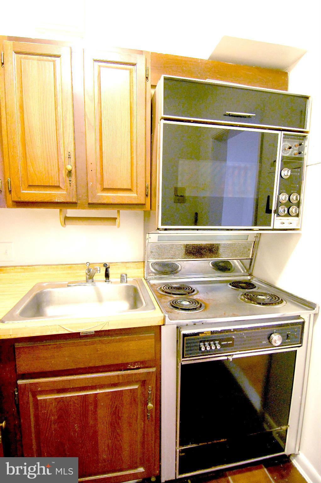 4000 Beecher Street Northwest, Unit 101 Washington, DC 20007 - Photo 9 of 26 a stove top oven sitting inside of a kitchen