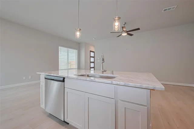 a bathroom with a granite countertop sink a toilet and mirror