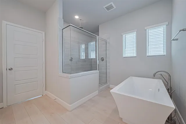 a bathroom with a granite countertop sink a mirror and a shower