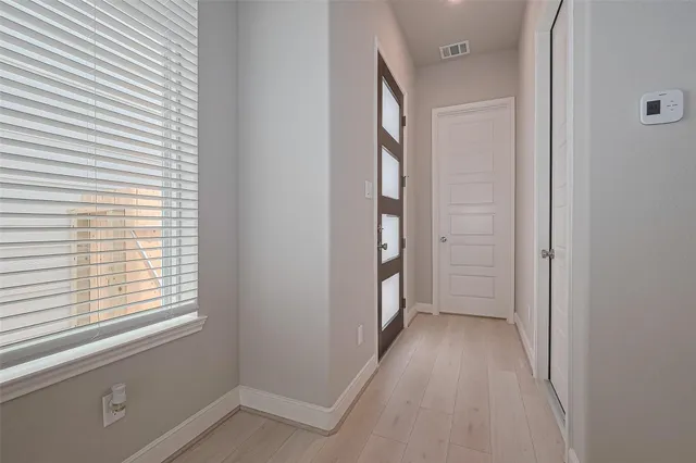 wooden floor in a room next to a window