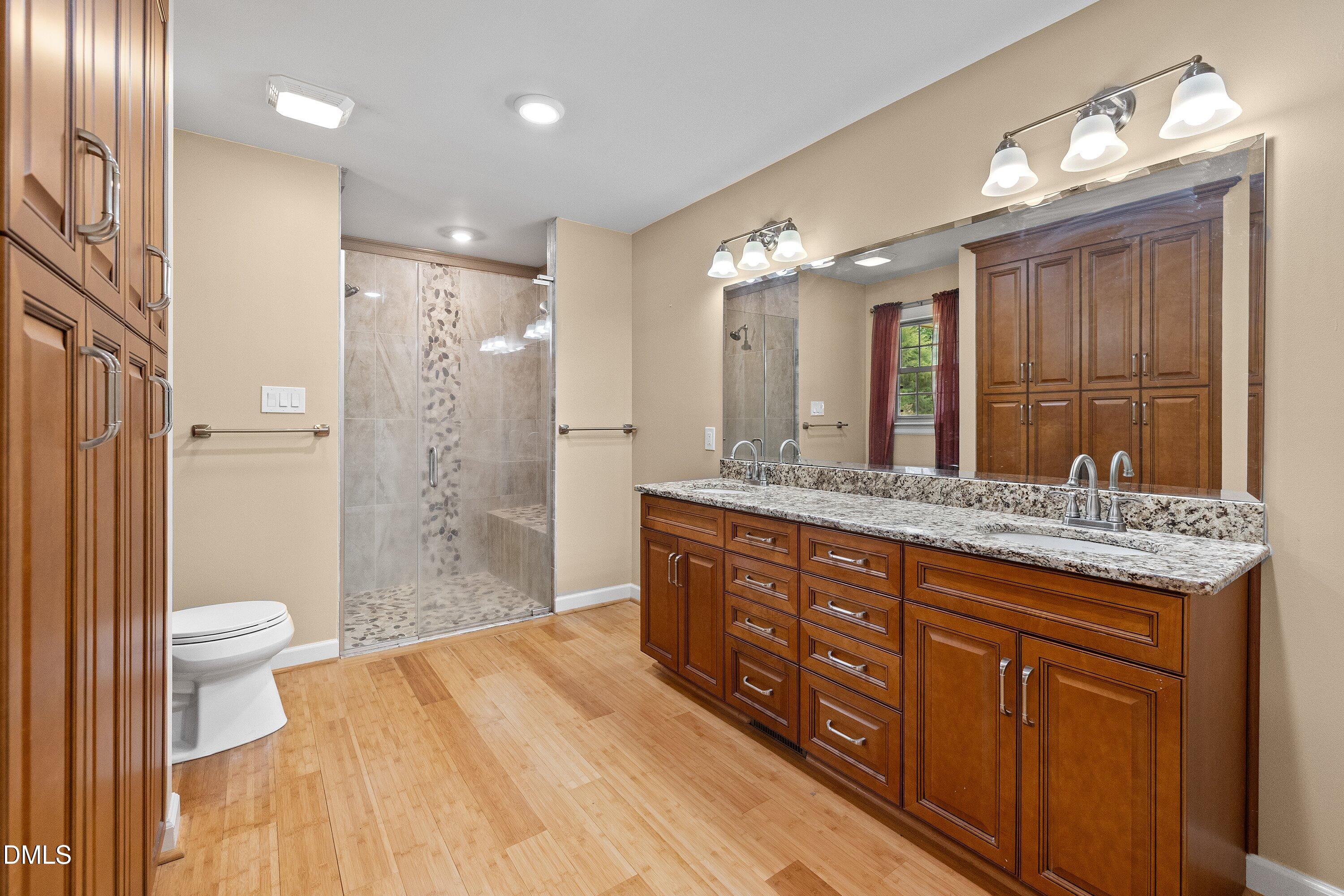 8133 Holly Forest Road Wake Forest, NC 27587 - Photo 26 of 50 a bathroom with a granite countertop sink toilet and shower