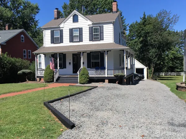 a front view of a house with a yard and porch