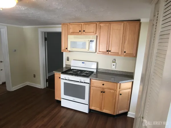 a kitchen with wooden floors and a stove