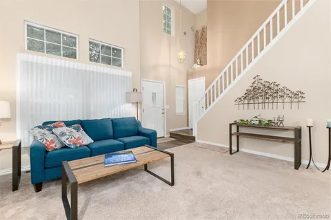 a living room with furniture and a table