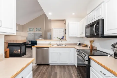 a kitchen with stainless steel appliances granite countertop a stove sink and cabinets