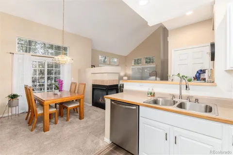 a kitchen that has a table and chairs in it