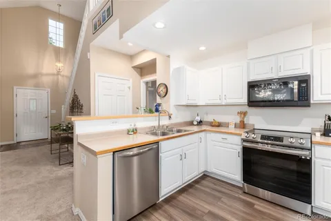 a kitchen with a sink stove and microwave