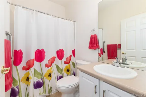 a bathroom with a sink toilet and shower curtain