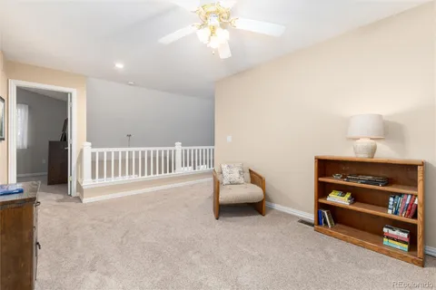 a view of a livingroom with furniture and a ceiling fan