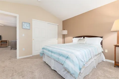a bedroom with a bed and a night stand