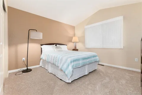 a bedroom with a bed and a night stand