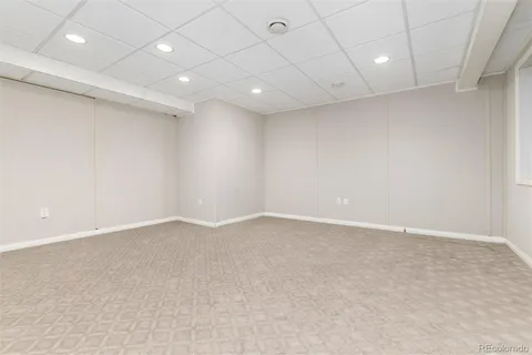 an empty room with a empty space and windows