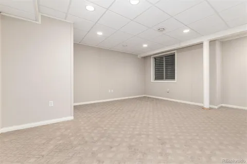 an empty room with a empty space and windows
