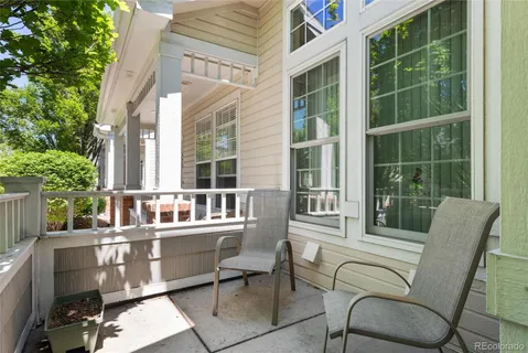 a balcony with table and chairs