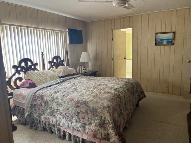 a bedroom with a bed and a lamp