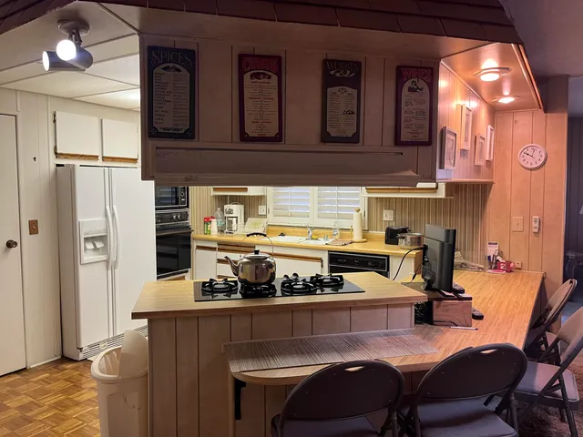 a kitchen with a stove a refrigerator and a sink