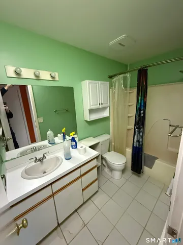 a bathroom with a sink toilet and a mirror