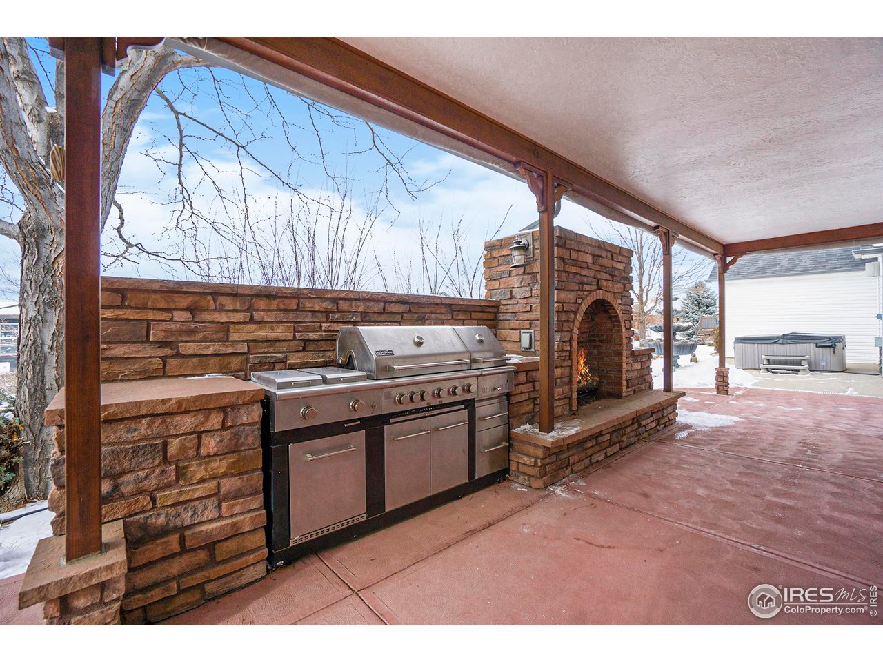 1430 Falcon Ridge Road Eaton, CO 80615 - Photo 28 of 34 Luxury outdoor stone fireplace/grill space