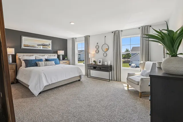 a bedroom with a large bed and a couch