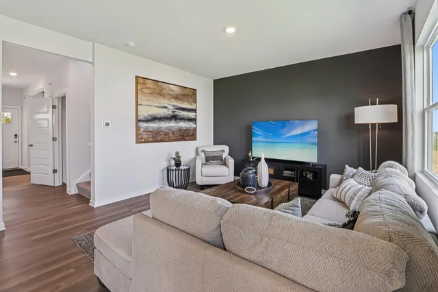 a living room with furniture and wooden floor