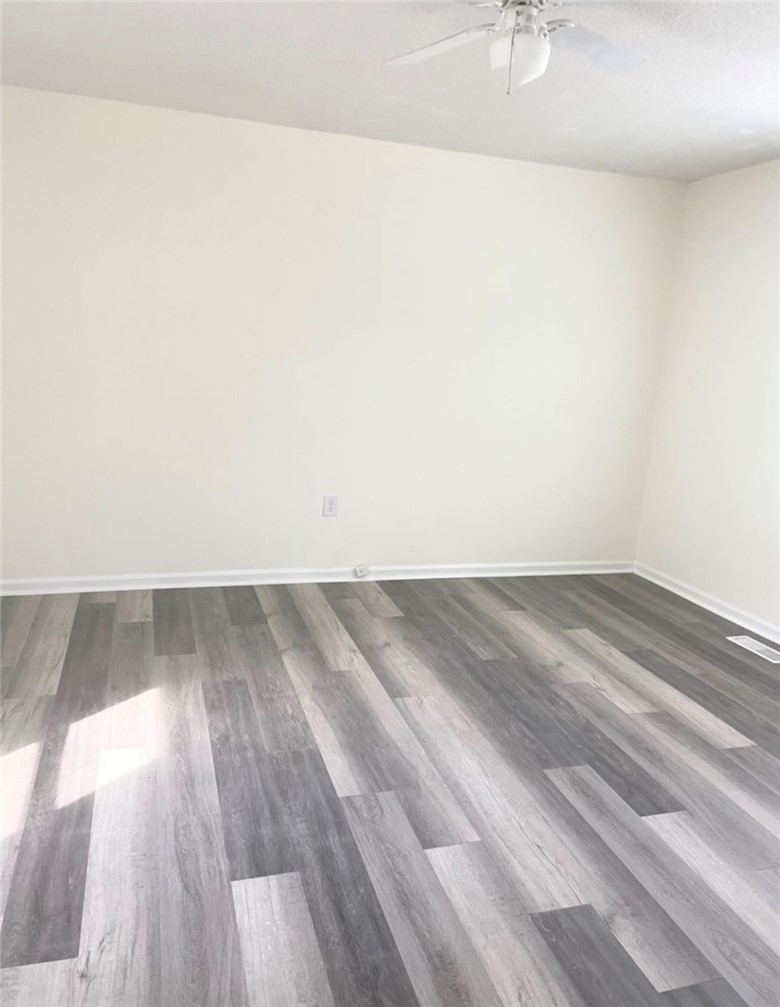 208 Hampton Street Iva, SC 29655 - Photo 3 of 19 This versatile room features durable flooring and a refreshing ceiling fan.