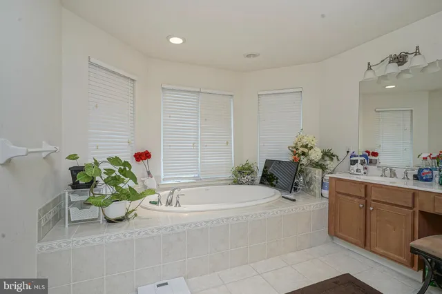 a bath tub sitting in a bathroom next to a sink