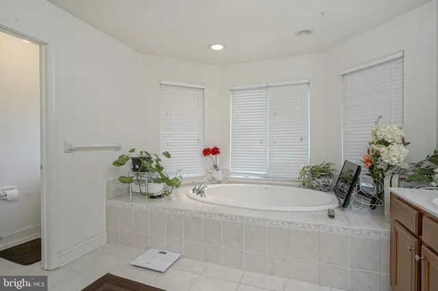 a white bath tub sitting next to a sink