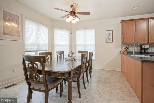 a view of a dining room with furniture and window