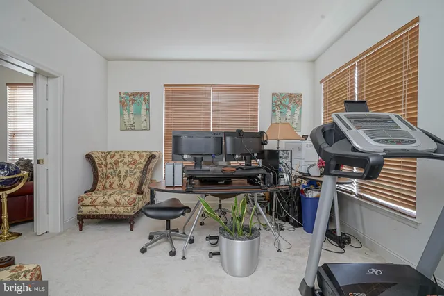 a view of a livingroom with workspace and a window