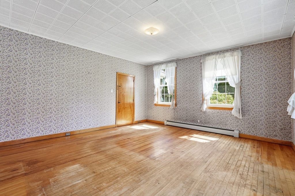15 Main Street Hatfield, MA 01038 - Photo 7 of 42 an empty room with wooden floor and windows