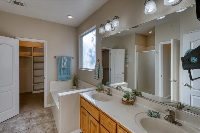 a bathroom with a sink vanity and a mirror