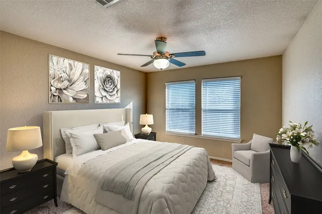 a backyard of a house with plants and large trees