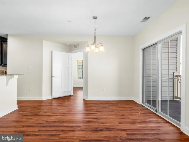a view of a room with wooden floor and windows