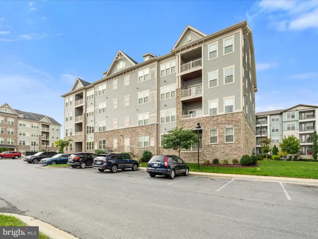 a buildings with car parked in front of it